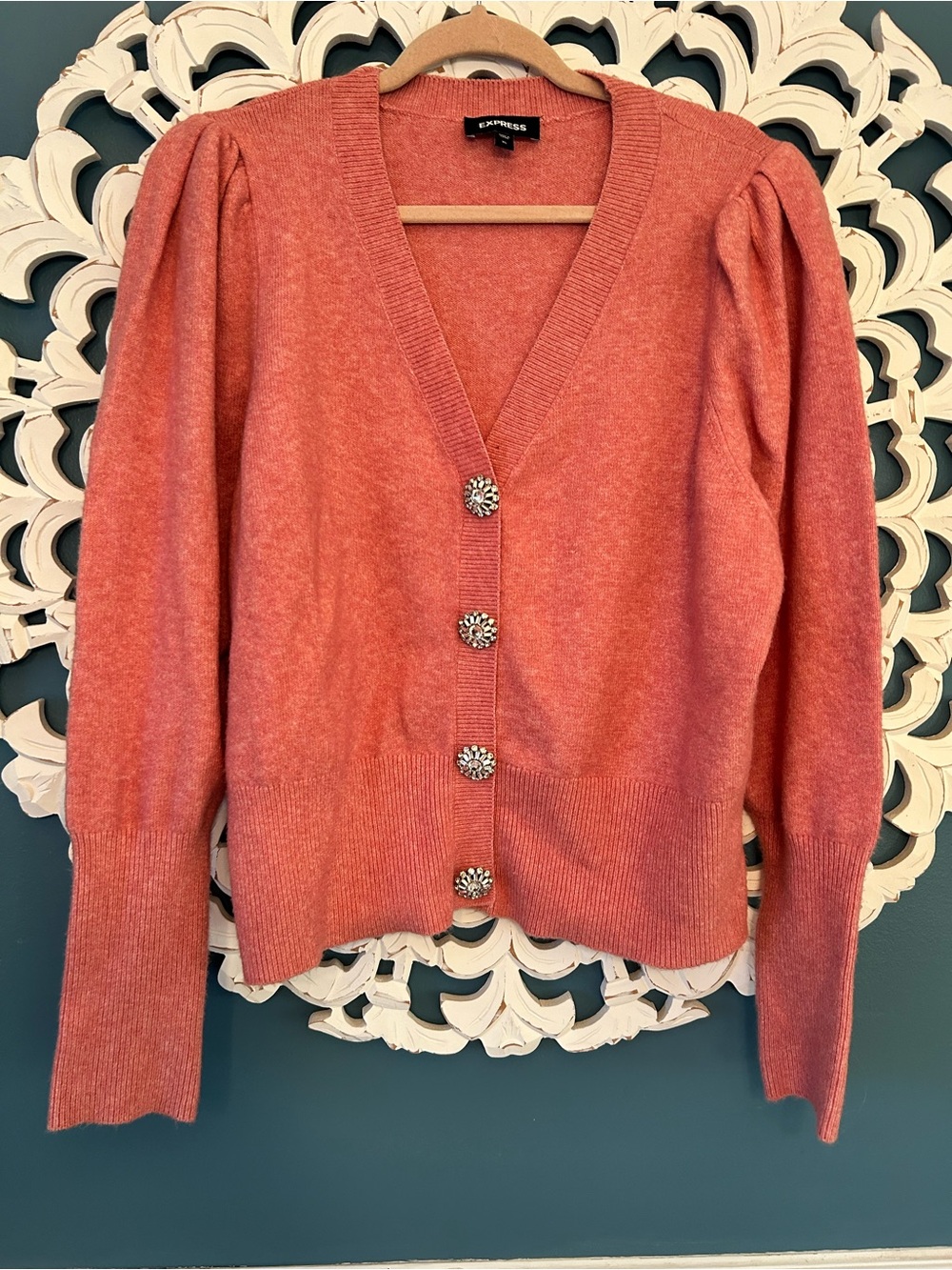 Express rose-pink cardigan features eye-catching, crystal-style jewel buttons